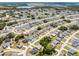 This aerial view shows a vast residential area with neatly spaced homes and winding streets, surrounded by wooded areas at 236 Elm Ct, Kissimmee, FL 34759