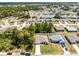 This aerial view showcases a single-story home with a long driveway, nestled among lush trees and green lawns at 236 Elm Ct, Kissimmee, FL 34759