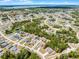 This aerial view offers a glimpse of a charming neighborhood featuring diverse homes, a pond, and winding roads at 236 Elm Ct, Kissimmee, FL 34759