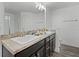 Bathroom with double sink vanity, granite countertop, and modern fixtures at 236 Elm Ct, Kissimmee, FL 34759