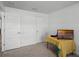 Bright bedroom with multiple closets and a table beneath a TV at 236 Elm Ct, Kissimmee, FL 34759