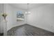 Bright dining area features a modern chandelier and wood-look flooring at 236 Elm Ct, Kissimmee, FL 34759