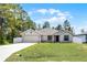 Charming single-story home with a well-manicured lawn and a two-car garage at 236 Elm Ct, Kissimmee, FL 34759