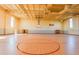 Spacious gymnasium with gleaming hardwood floors, high ceilings, and basketball hoops, perfect for sports and recreation at 236 Elm Ct, Kissimmee, FL 34759