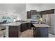 Modern kitchen with stainless steel appliances, dark cabinets, and granite countertops at 236 Elm Ct, Kissimmee, FL 34759