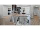 Open kitchen with stainless steel appliances, breakfast bar, and views of the dining area and laundry room at 236 Elm Ct, Kissimmee, FL 34759