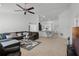Open concept living room and kitchen with a breakfast bar and access to the laundry room at 236 Elm Ct, Kissimmee, FL 34759