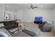 Bright and airy living room with a ceiling fan, neutral tones, and an open layout at 236 Elm Ct, Kissimmee, FL 34759