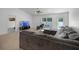 Comfortable living room with large sectional, window, and access to the backyard at 236 Elm Ct, Kissimmee, FL 34759