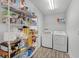 Pantry features a large metal rack and newer washer and dryer at 236 Elm Ct, Kissimmee, FL 34759