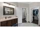 Bathroom featuring wood vanity, decorative lighting, and walk-in closet at 243 Sagecrest Dr, Ocoee, FL 34761
