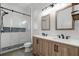 Bathroom featuring double vanity, glass shower, and decorative lighting at 243 Sagecrest Dr, Ocoee, FL 34761