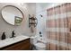 Charming bathroom with updated vanity, round mirror, and a shower with a decorative curtain at 243 Sagecrest Dr, Ocoee, FL 34761