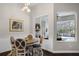 Dining room with wood floors, elegant lighting, wainscotting, and views of the pool at 243 Sagecrest Dr, Ocoee, FL 34761