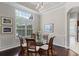 Bright dining room featuring a glass table, decorative lighting, and large windows at 243 Sagecrest Dr, Ocoee, FL 34761