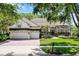 Charming two-story home with a three car garage, brick driveway, and lush landscaping at 243 Sagecrest Dr, Ocoee, FL 34761