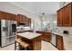 Open kitchen with granite countertops, stainless appliances, tile floors, and dark wood cabinets at 243 Sagecrest Dr, Ocoee, FL 34761
