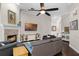 Living room with fireplace, vaulted ceilings, and dark wood floors that opens to other rooms at 243 Sagecrest Dr, Ocoee, FL 34761