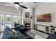 Living room with fireplace, vaulted ceilings, dark wood floors, and access to the outdoor patio at 243 Sagecrest Dr, Ocoee, FL 34761