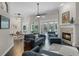 Open concept living room with fireplace, vaulted ceilings, wood floors and pool views at 243 Sagecrest Dr, Ocoee, FL 34761
