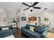 Open concept living room and kitchen with vaulted ceilings, dark wood floors, and neutral decor at 243 Sagecrest Dr, Ocoee, FL 34761