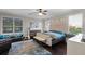 Bright main bedroom featuring a ceiling fan, area rug, and natural light from large windows at 243 Sagecrest Dr, Ocoee, FL 34761