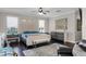 Bright main bedroom featuring a large area rug, ceiling fan, and natural light from large windows at 243 Sagecrest Dr, Ocoee, FL 34761