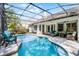 Serene in-ground pool with screened enclosure, outdoor seating, and views of the home's exterior at 243 Sagecrest Dr, Ocoee, FL 34761