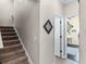 Carpeted staircase with neutral walls, leading to an open doorway and living space at 243 Sagecrest Dr, Ocoee, FL 34761