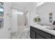 Well-lit bathroom featuring a shower-tub combination, vanity, and framed art at 248 Wallrock Ct, Ocoee, FL 34761