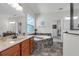 Bright bathroom with granite counters, dual sinks, a soaking tub, and lots of natural light at 248 Wallrock Ct, Ocoee, FL 34761