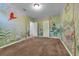 Bedroom with jungle themed wall art and two entry doors at 248 Wallrock Ct, Ocoee, FL 34761