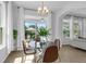 Bright breakfast nook with modern furniture, light fixture and a view of the backyard at 248 Wallrock Ct, Ocoee, FL 34761