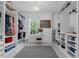 Spacious walk-in closet with custom shelving and a large window overlooking a green space at 248 Wallrock Ct, Ocoee, FL 34761