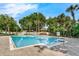 Large, sparkling community pool surrounded by mature trees and landscaping with a gazebo at 248 Wallrock Ct, Ocoee, FL 34761