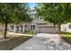 Charming two-story home featuring a two-car garage and beautifully landscaped front yard with mature trees at 248 Wallrock Ct, Ocoee, FL 34761