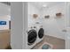Tidy laundry room with shelving and modern washer and dryer at 248 Wallrock Ct, Ocoee, FL 34761