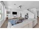 Bright living room with tile flooring, large windows, and comfortable modern sectional sofa at 248 Wallrock Ct, Ocoee, FL 34761