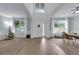 Bright open-concept living room with high ceilings, large windows, and neutral decor for versatile styling at 248 Wallrock Ct, Ocoee, FL 34761