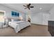 Spacious main bedroom with carpeting, a ceiling fan, and an ensuite bathroom at 248 Wallrock Ct, Ocoee, FL 34761