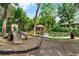 Community playground with a slide, gazebo, seating and landscaping with trees at 248 Wallrock Ct, Ocoee, FL 34761