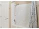 Bathroom showing a shower and tub combo with white tile surround and a decorative shower curtain at 2509 Archfeld Blvd, Kissimmee, FL 34746