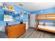 Fun bedroom with a bunk bed, dresser, and creative wall design perfect for a imagination at 2509 Archfeld Blvd, Kissimmee, FL 34746