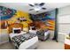 Quirky bedroom has twin beds, creative space murals and a space themed ceiling fan at 2509 Archfeld Blvd, Kissimmee, FL 34746