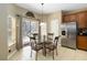 Dining area features a glass table, backyard access, stainless steel refrigerator, and ample natural light at 2509 Archfeld Blvd, Kissimmee, FL 34746