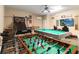 Inviting game room with foosball, pool table, and basketball, perfect for entertainment at 2509 Archfeld Blvd, Kissimmee, FL 34746