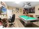 Finished game room with large screen TV and pool table, offering ample entertainment space at 2509 Archfeld Blvd, Kissimmee, FL 34746