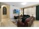 Living room showcases a geometric accent wall with a mounted TV and comfortable leather seating arrangement at 2509 Archfeld Blvd, Kissimmee, FL 34746