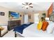 Bright main bedroom with a ceiling fan, tv, and colorful decor creating a relaxing space at 2509 Archfeld Blvd, Kissimmee, FL 34746