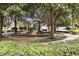 Community playground featuring slides, climbing structures, and mature trees providing shade in a park-like setting at 2509 Archfeld Blvd, Kissimmee, FL 34746